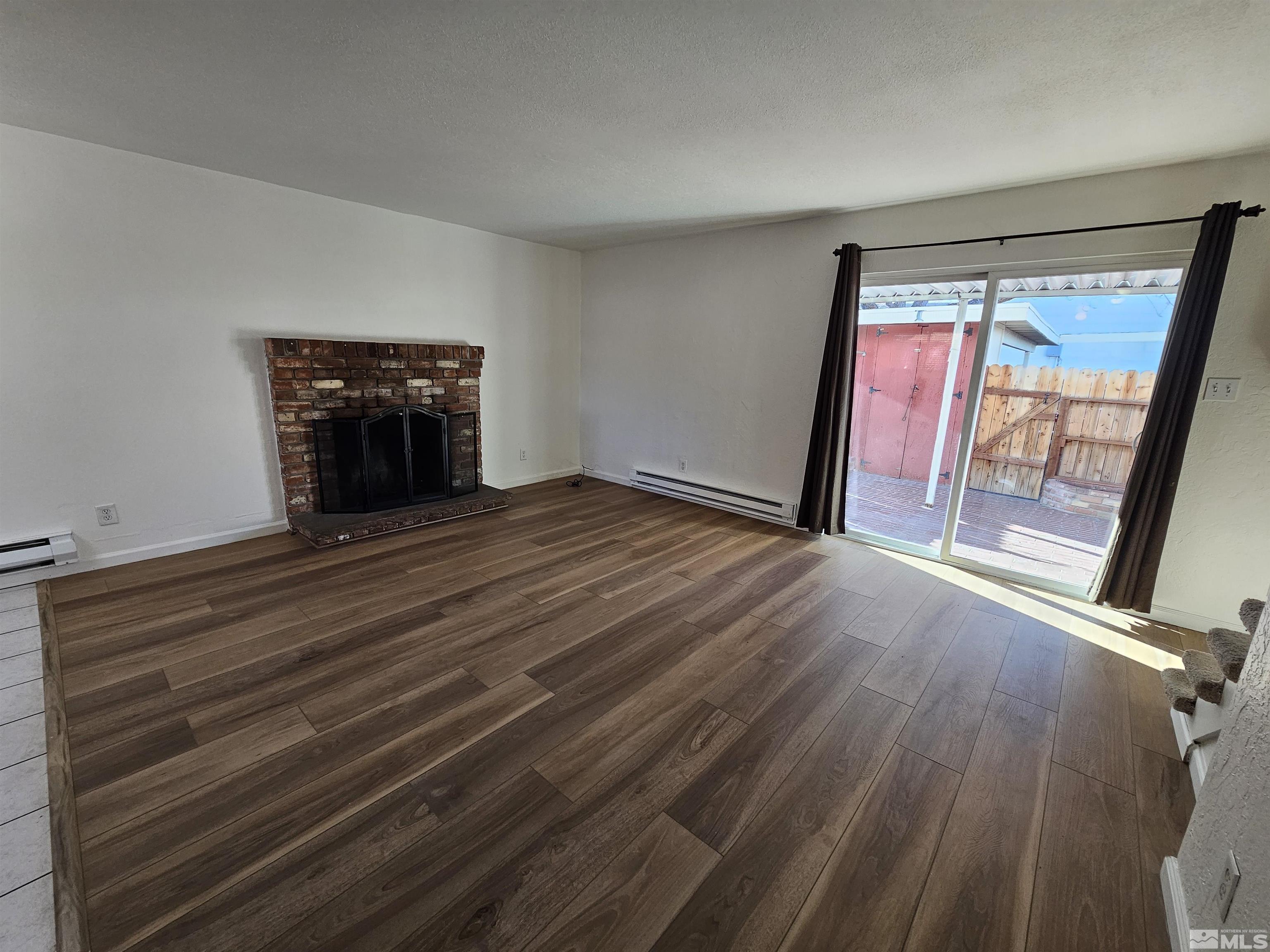 163 Smithridge Park Reno, NV 89502 - Photo 7 of 28 a view of an empty room with wooden floor and a window