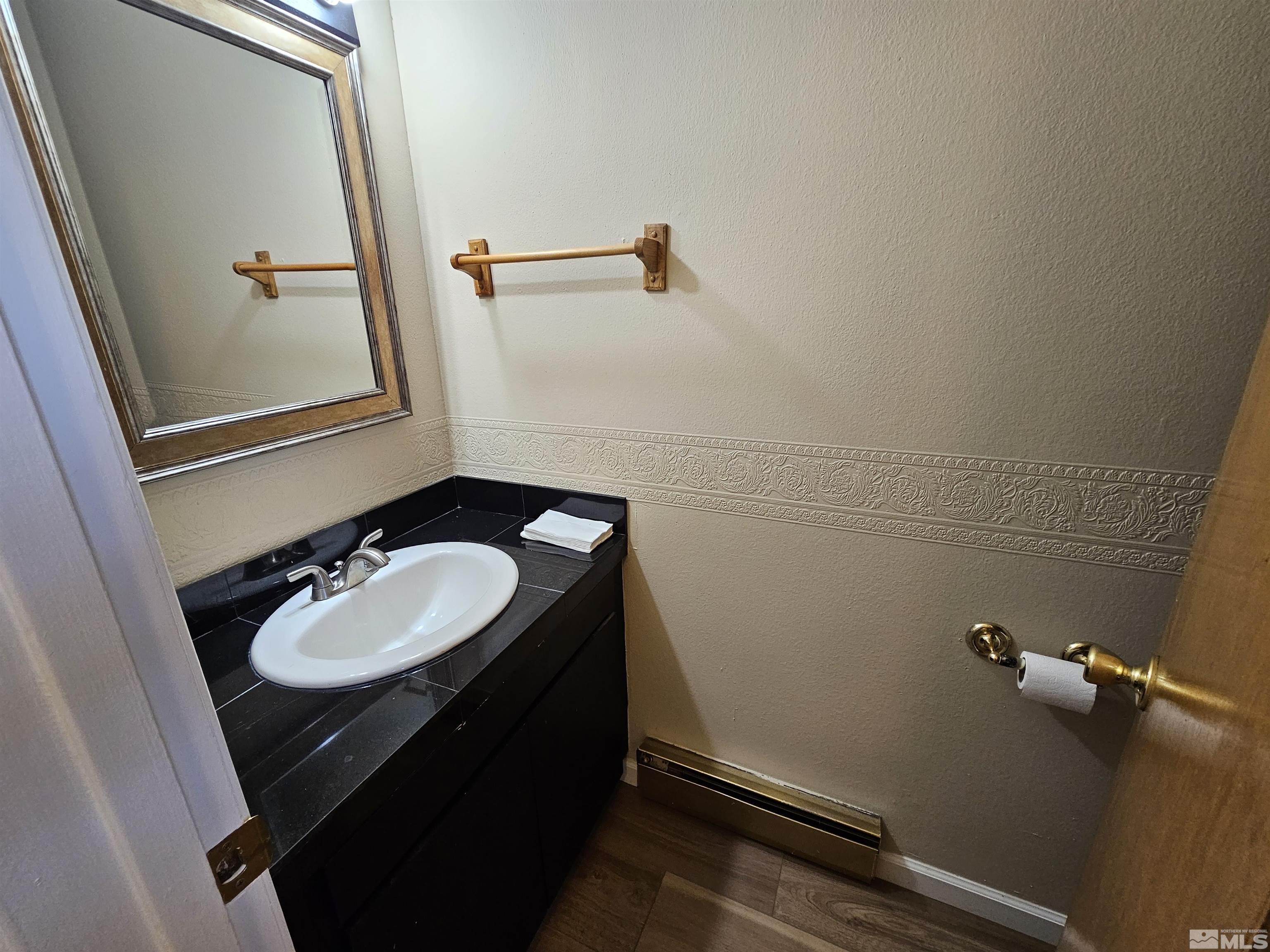163 Smithridge Park Reno, NV 89502 - Photo 9 of 28 a bathroom with a sink and a mirror