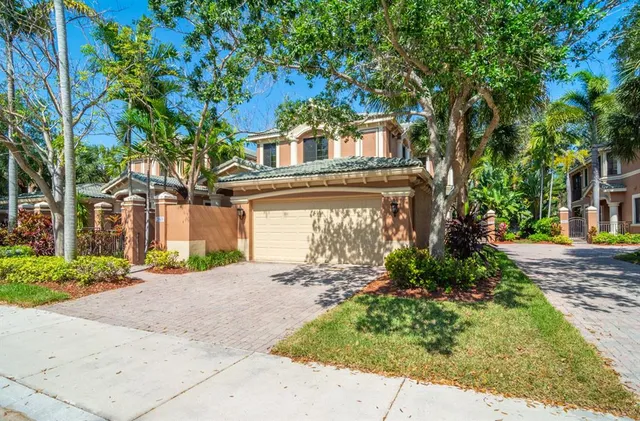 a front view of a house with a yard and a garage