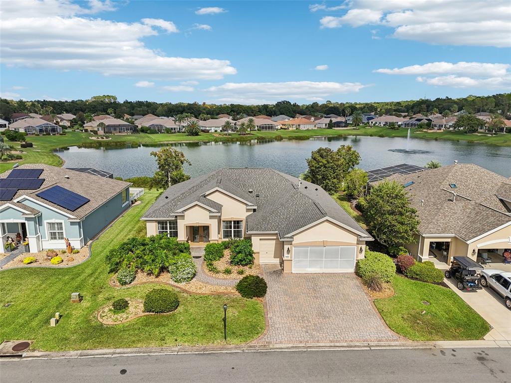 an aerial view of house with yard and lake view