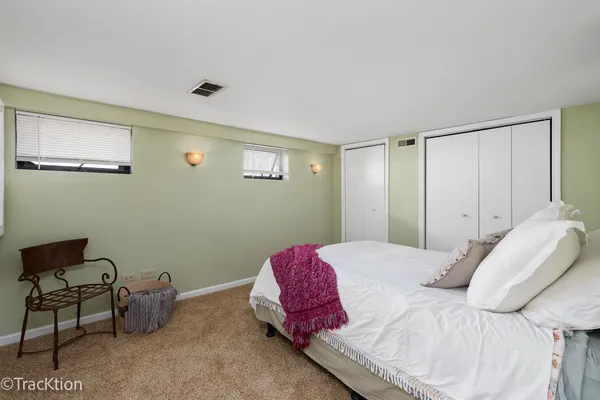 a bedroom with a bed and a chair