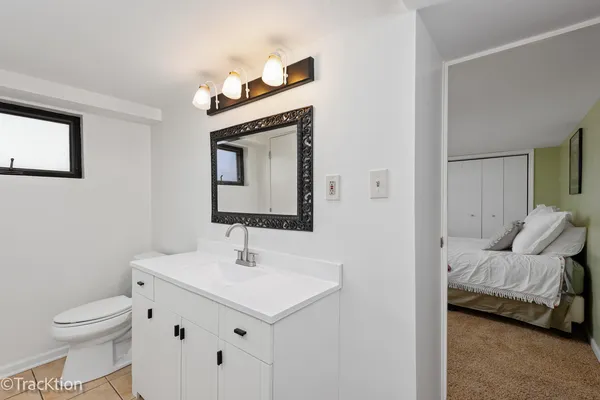 a en suite bathroom with a toilet sink and mirror