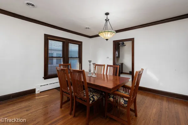 a view of a dining room with furniture wooden floor and chandelier