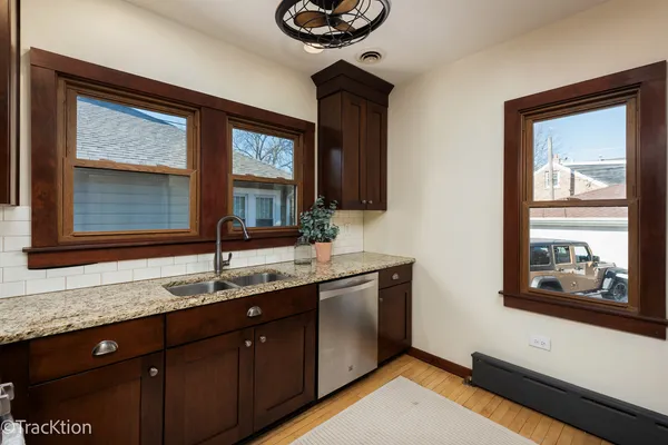 a bathroom with a granite countertop sink a large mirror and a window
