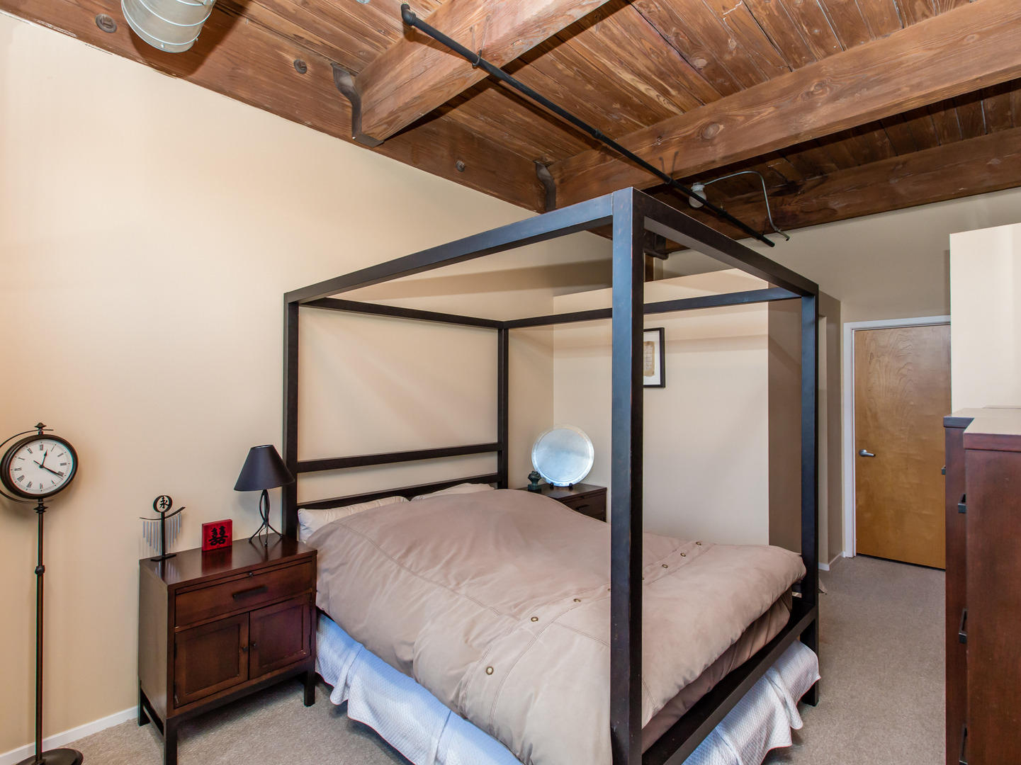 1500 West Monroe Street, Unit 524 Chicago, IL 60607 - Photo 11 of 20 a bedroom with a bed and a mirror