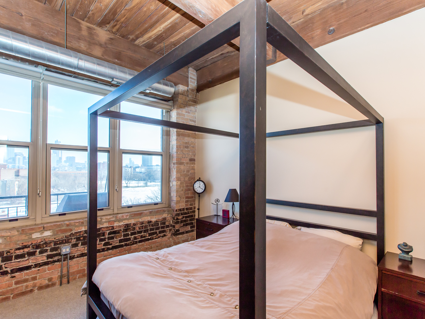 1500 West Monroe Street, Unit 524 Chicago, IL 60607 - Photo 12 of 20 a bedroom with a bed and a large window with the outer view