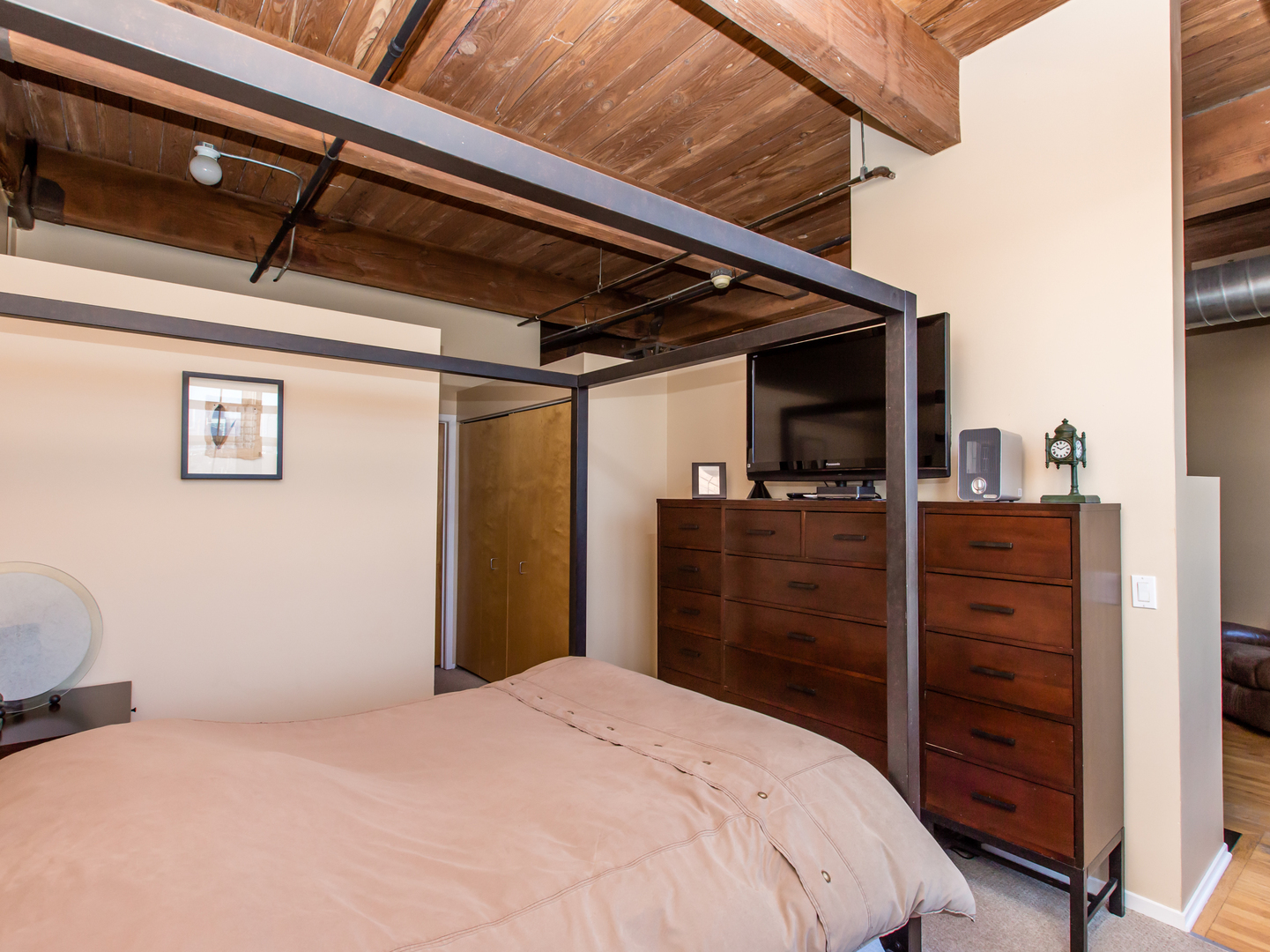 1500 West Monroe Street, Unit 524 Chicago, IL 60607 - Photo 13 of 20 a bedroom with a bed and a dresser