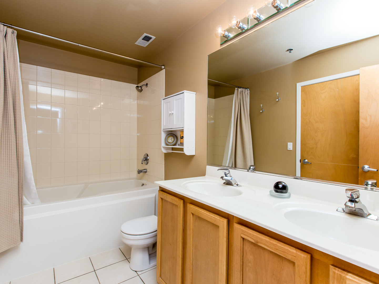 1500 West Monroe Street, Unit 524 Chicago, IL 60607 - Photo 16 of 20 a bathroom with a double vanity sink toilet mirror and shower