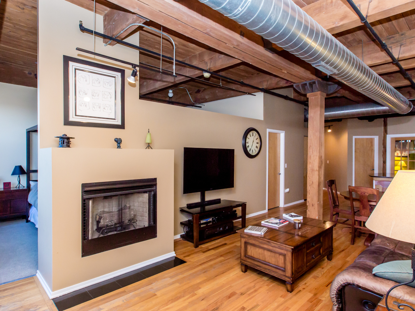 1500 West Monroe Street, Unit 524 Chicago, IL 60607 - Photo 3 of 20 a living room with furniture a flat screen tv and a fireplace