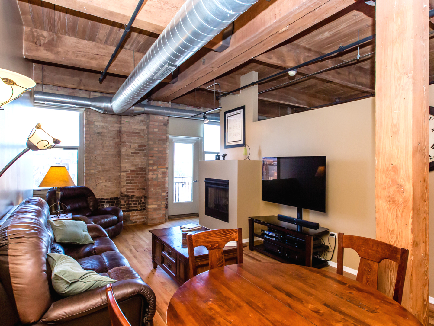 1500 West Monroe Street, Unit 524 Chicago, IL 60607 - Photo 4 of 20 a living room with furniture and a flat screen tv
