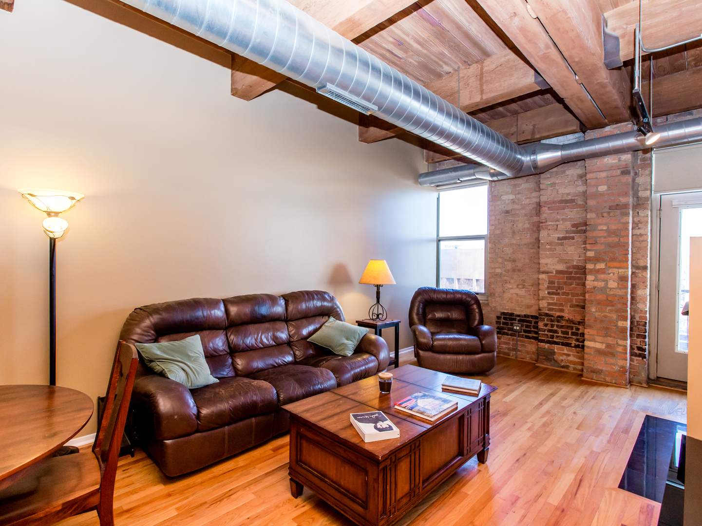 1500 West Monroe Street, Unit 524 Chicago, IL 60607 - Photo 6 of 20 a living room with furniture a wooden floor and next to a window