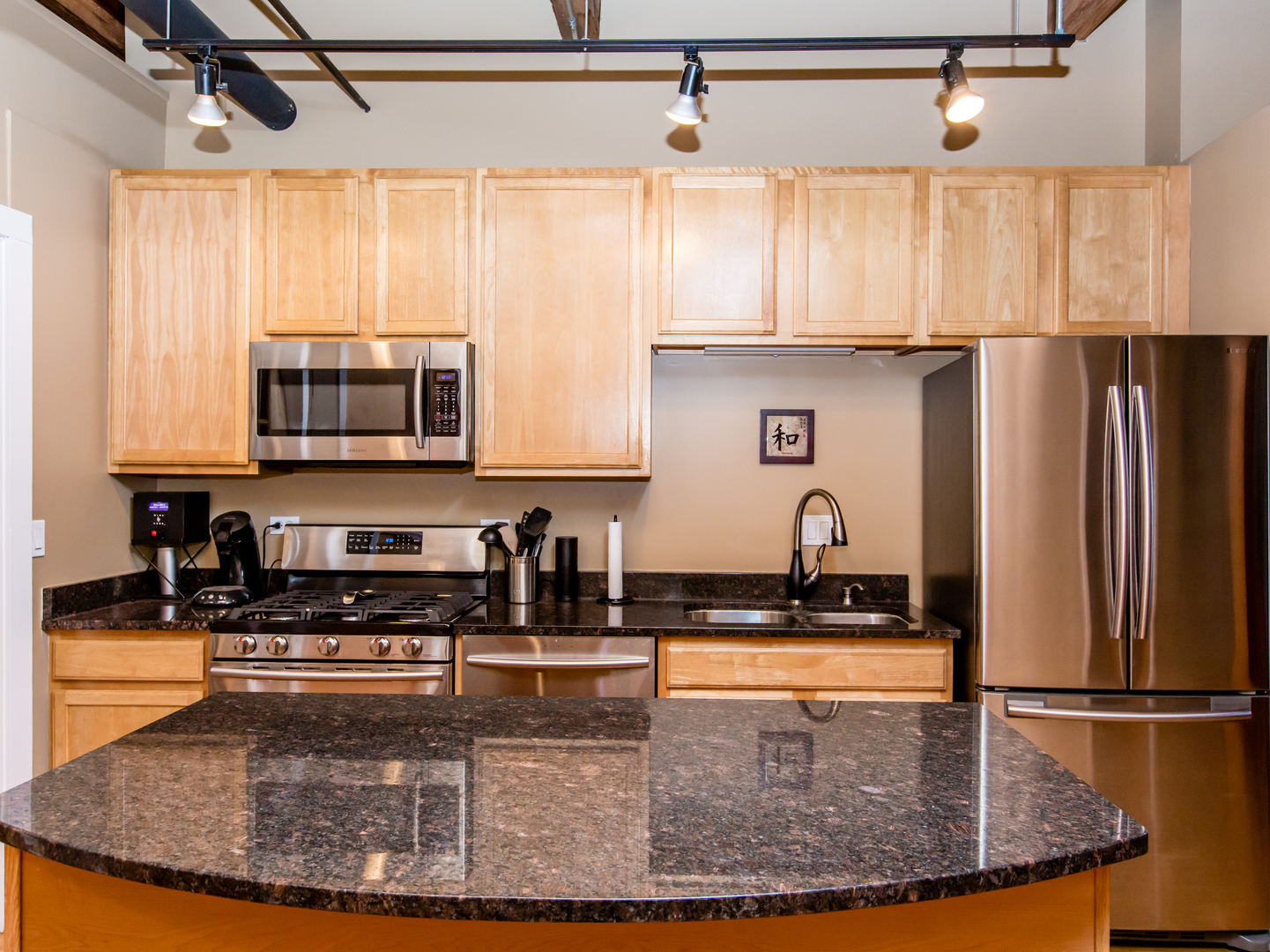 1500 West Monroe Street, Unit 524 Chicago, IL 60607 - Photo 7 of 20 a kitchen with kitchen island a counter top space cabinets a sink and a window