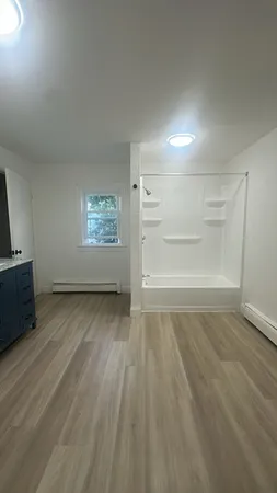 wooden floor in an empty room with a window