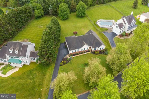 an aerial view of a residential houses with outdoor space