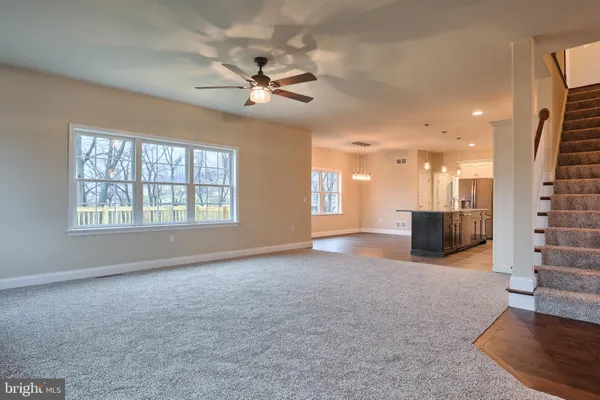 a view of an empty room with a window and fireplace