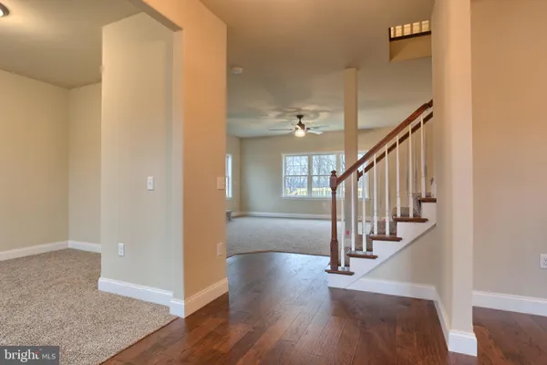 a view of entryway and hall with wooden floor