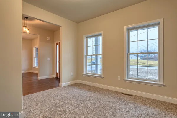 an empty room with windows and closet