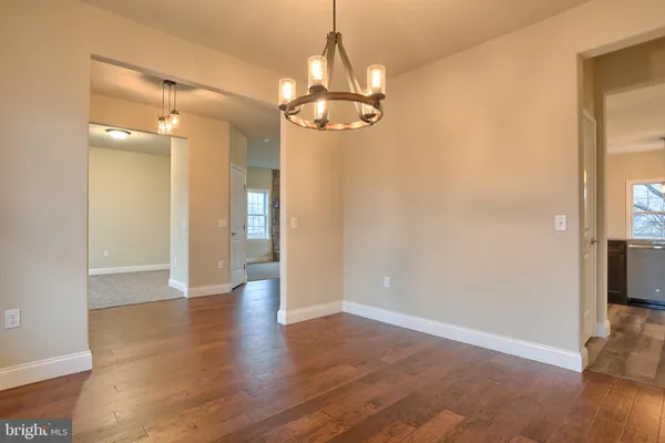 wooden floor in an empty room with a mirror