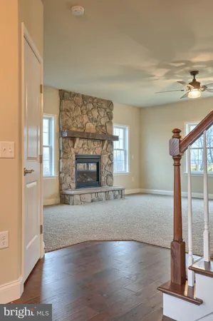 a view of an empty room with a fireplace and a window