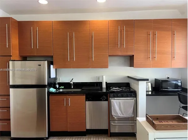 a kitchen with a refrigerator and a stove