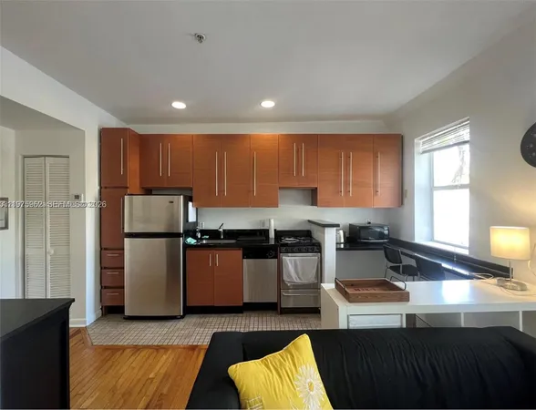 a kitchen with stainless steel appliances granite countertop a refrigerator sink and stove