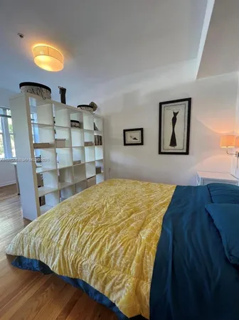 a bed sitting in a bedroom and dressers