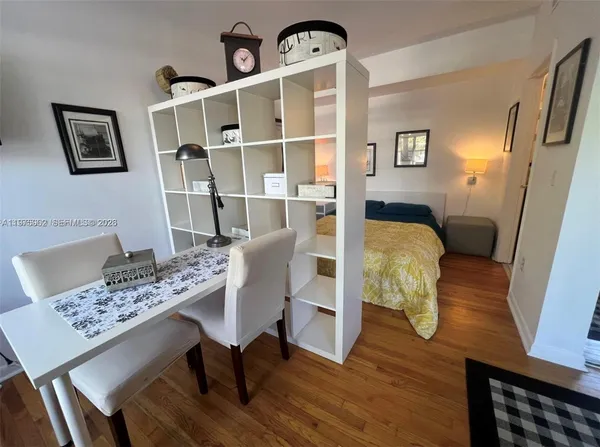 a view of a dining room with furniture window and wooden floor