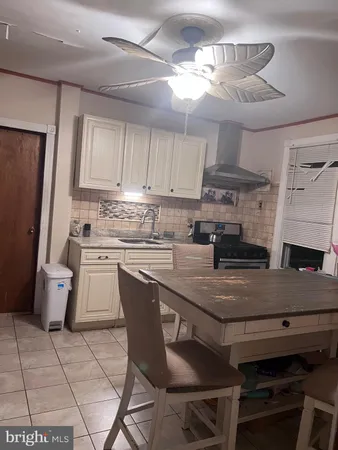 a kitchen with a table chairs and a refrigerator