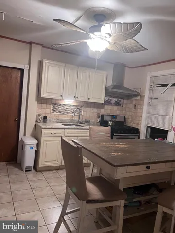 a kitchen with a table chairs and a refrigerator