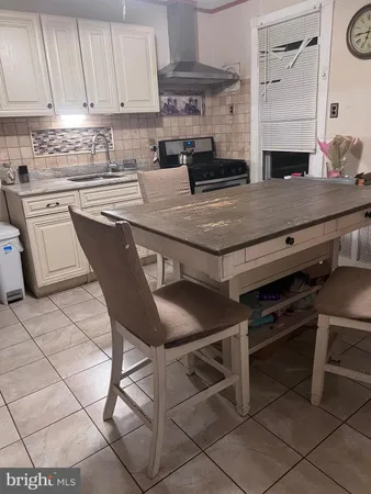 a kitchen with a table chairs and a stove