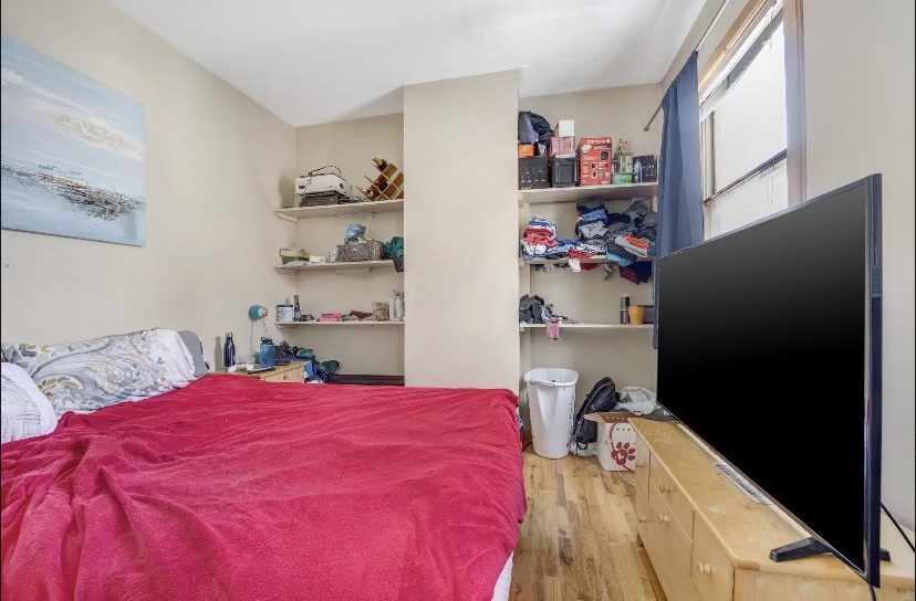 Undisclosed Address Chicago, IL 60657 - Photo 13 of 13 a bed room with a bed and a window