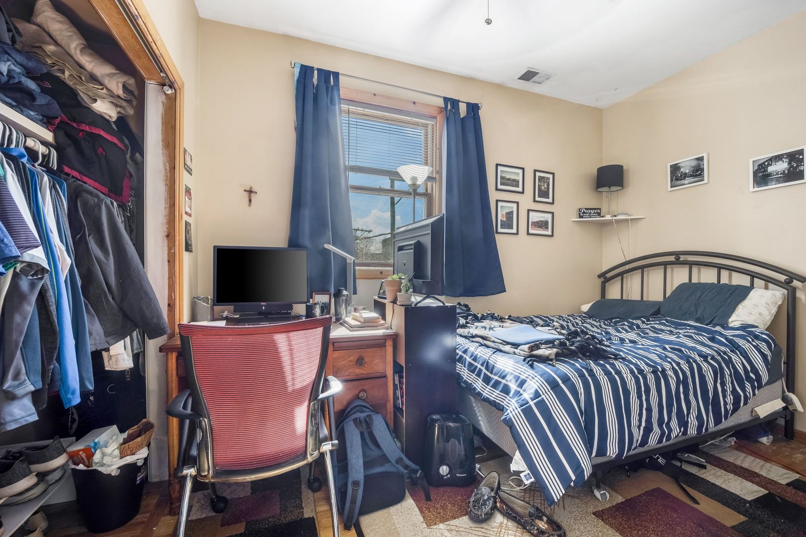 Undisclosed Address Chicago, IL 60657 - Photo 9 of 13 a bedroom with a bed a flat screen tv and dresser