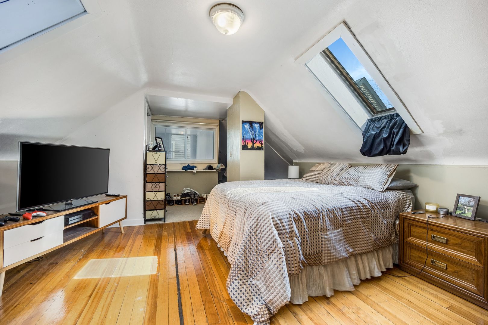 Undisclosed Address Chicago, IL 60657 - Photo 10 of 13 a bedroom with a bed and a flat tv screen on wall