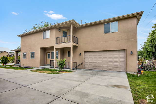 4 Hanauer Place Murray, UT 84107 - Photo 24 of 24 Townhome / multi-family property with a balcony, a garage, stucco siding, and driveway