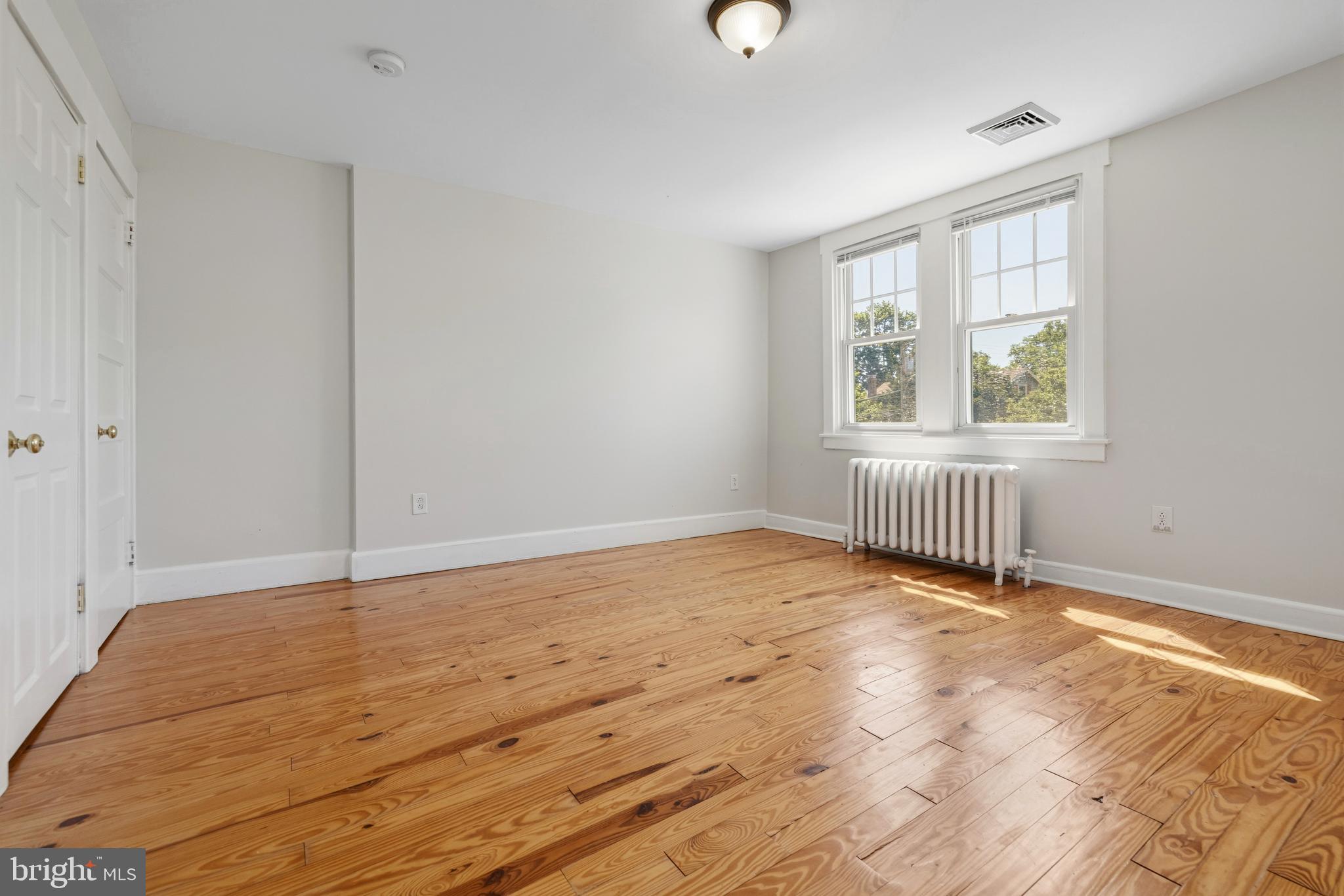 229 Wayne Avenue Narberth, PA 19072 - Photo 21 of 35 an empty room with wooden floor and windows