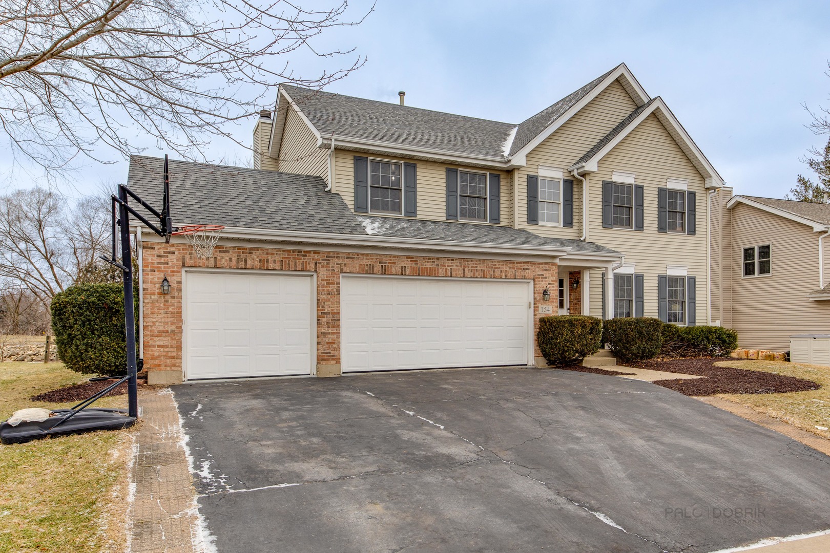 154 Barnes Road Elgin, IL 60124 - Photo 3 of 31 a front view of a house with a yard and garage