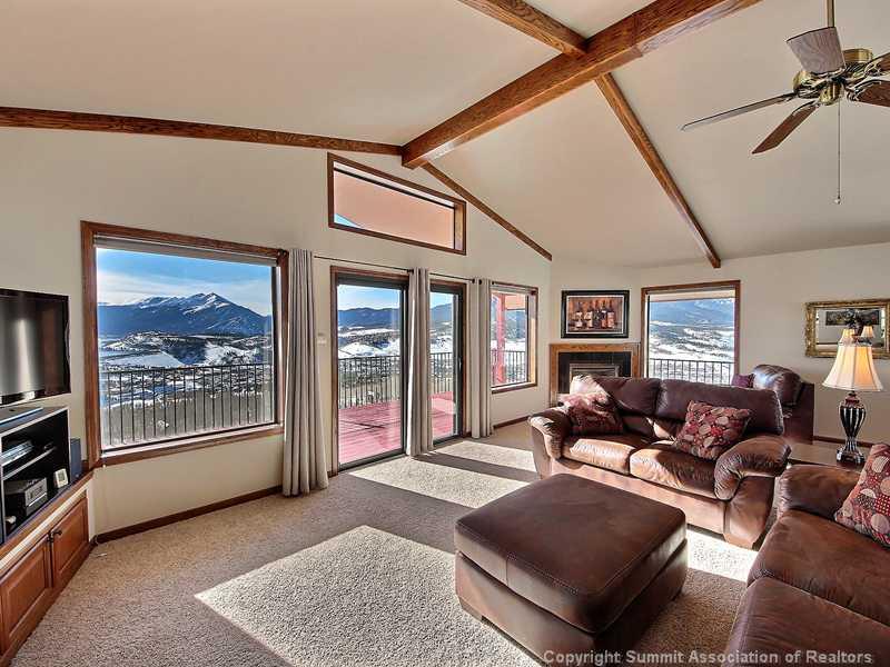 48 AB Road Silverthorne, CO 80498 - Photo 4 of 25 a living room with furniture a floor to ceiling window and a flat screen tv