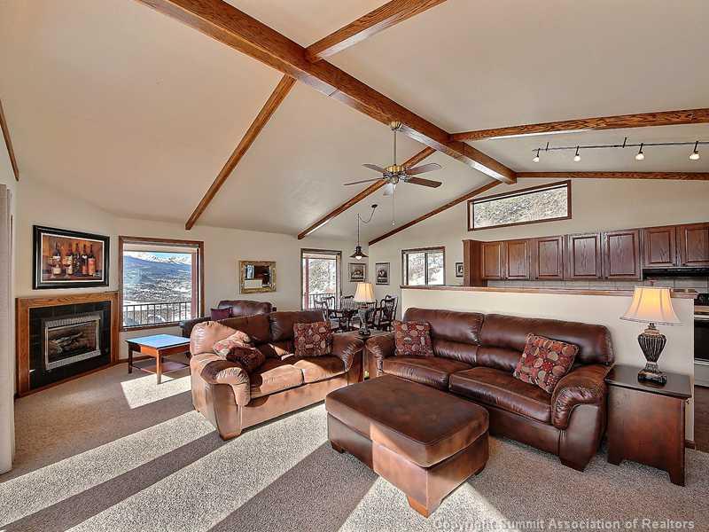 48 AB Road Silverthorne, CO 80498 - Photo 6 of 25 a living room with furniture a fireplace and a flat screen tv