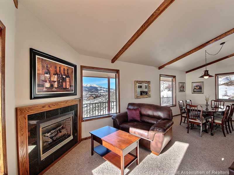 48 AB Road Silverthorne, CO 80498 - Photo 9 of 25 a living room with furniture a fireplace and windows