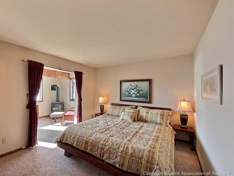 48 AB Road Silverthorne, CO 80498 - Photo 10 of 25 a bedroom with a bed and wooden floor