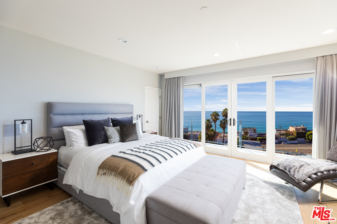 21370 Rambla Vista Malibu, CA 90265 - Photo 15 of 22 a bedroom with a bed and a large window