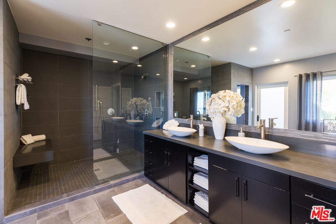 21370 Rambla Vista Malibu, CA 90265 - Photo 16 of 22 a bathroom with a double vanity sink and a mirror