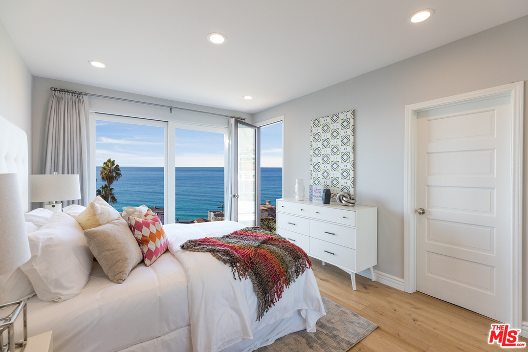 21370 Rambla Vista Malibu, CA 90265 - Photo 19 of 22 a bedroom with a bed and a window