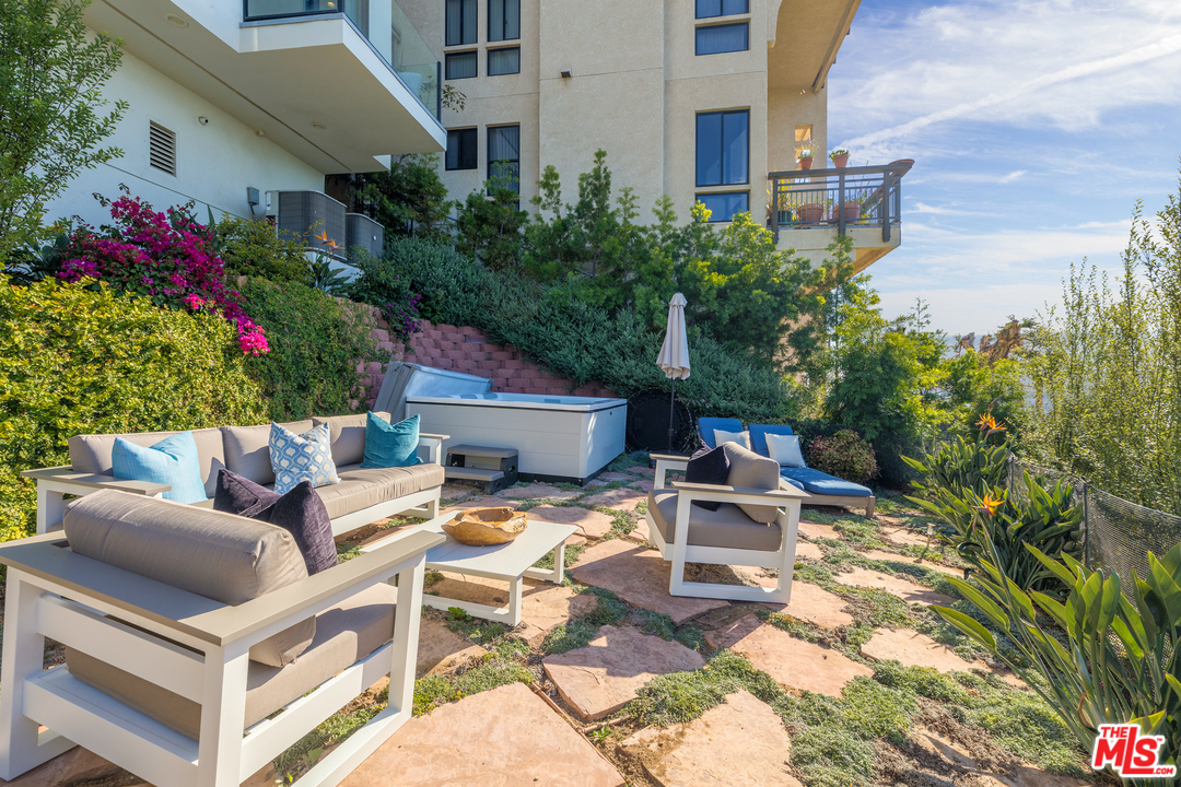 21370 Rambla Vista Malibu, CA 90265 - Photo 21 of 22 a view of a patio with table and chairs potted plants