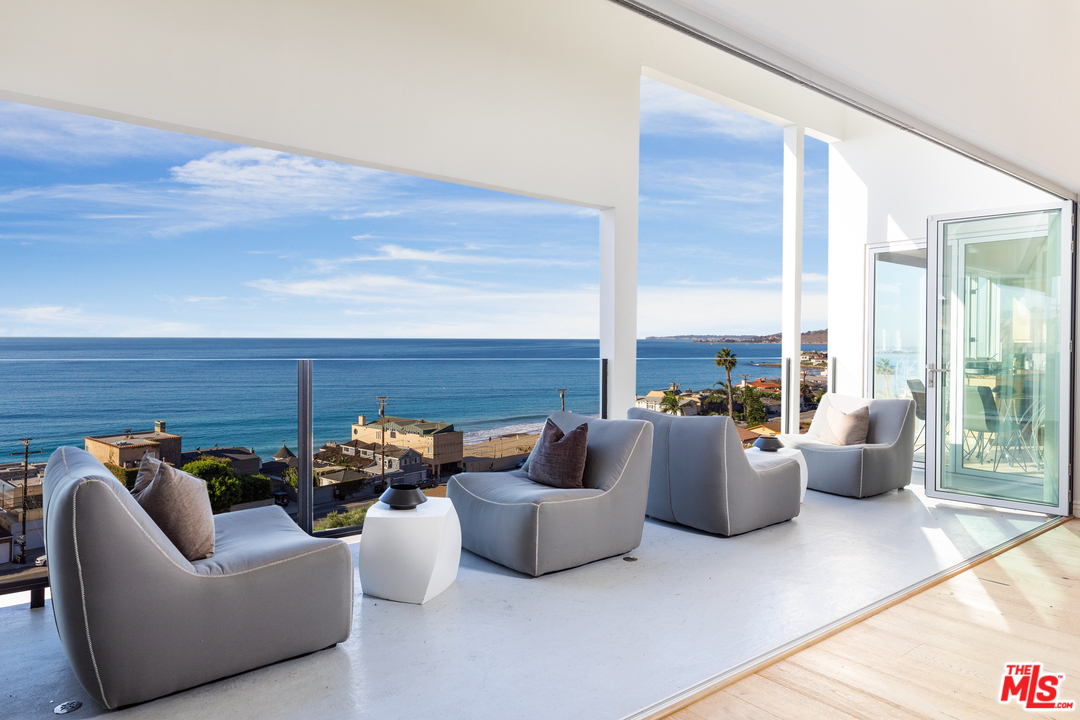 21370 Rambla Vista Malibu, CA 90265 - Photo 3 of 22 a living room with furniture and a potted plant