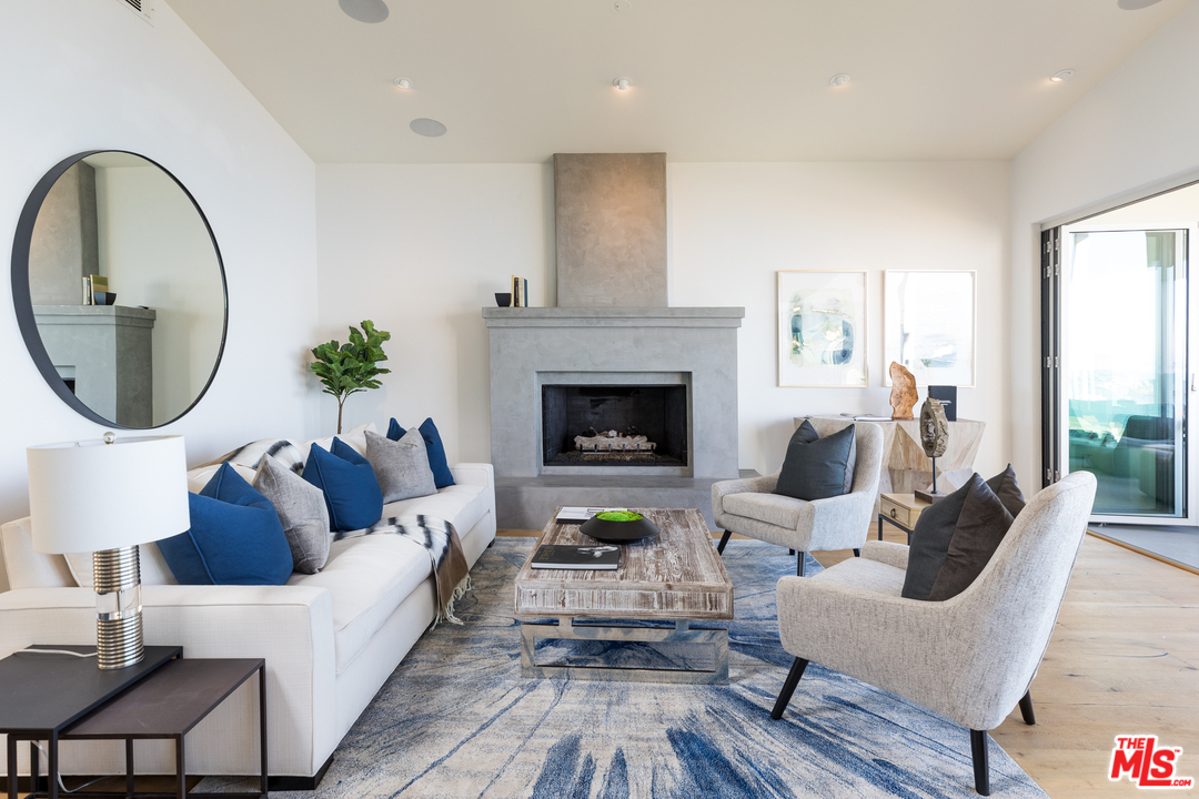 21370 Rambla Vista Malibu, CA 90265 - Photo 5 of 22 a living room with furniture and a fireplace