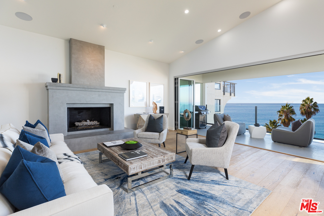 21370 Rambla Vista Malibu, CA 90265 - Photo 6 of 22 a living room with furniture and a fireplace