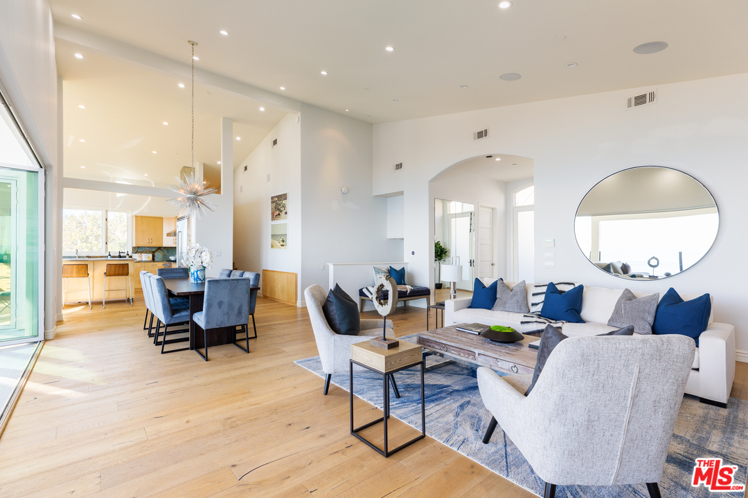 21370 Rambla Vista Malibu, CA 90265 - Photo 7 of 22 a living room with furniture and a large mirror