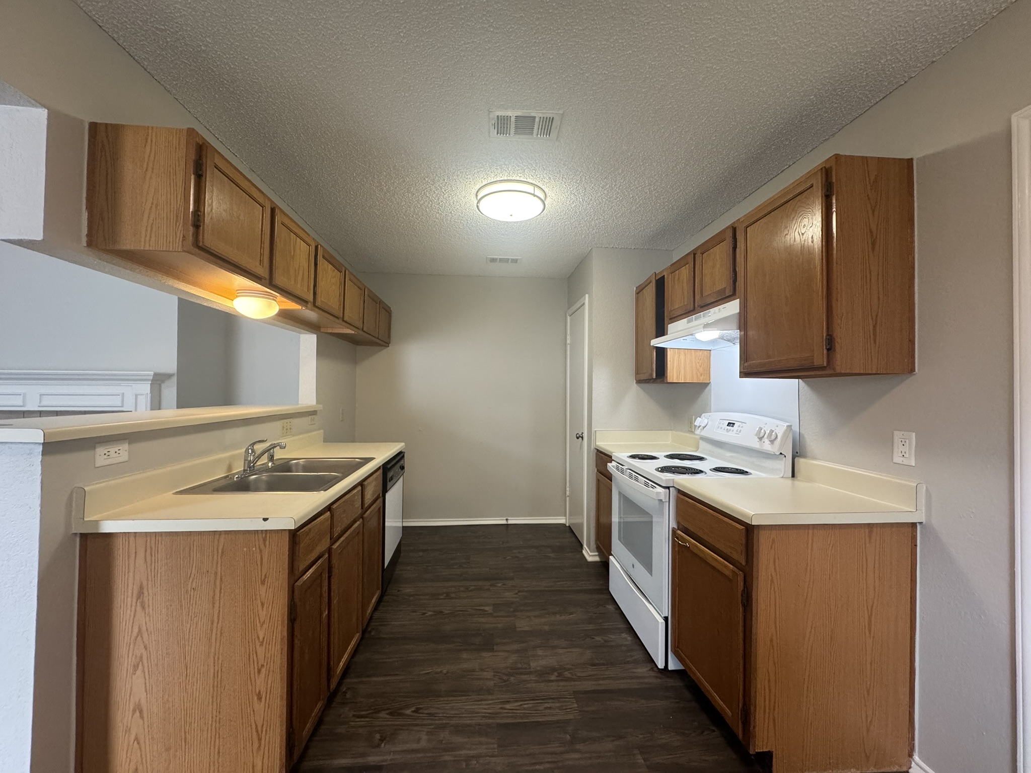 522 Cutty Trail, Unit B Lakeway, TX 78734 - Photo 8 of 20 Functional kitchen with ample cabinetry and a pass-through window to adjacent living space.