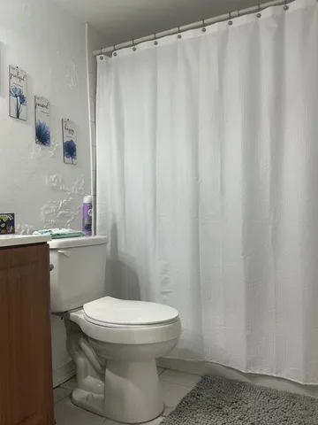 a bathroom with a sink mirror and toilet